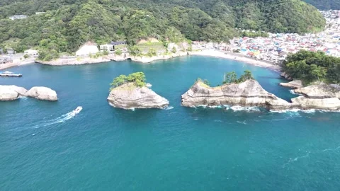 Sightseeing Boat Navigating Between Dogashima Islands│4K Drone Rotation Shot Stock Footage 326081733
