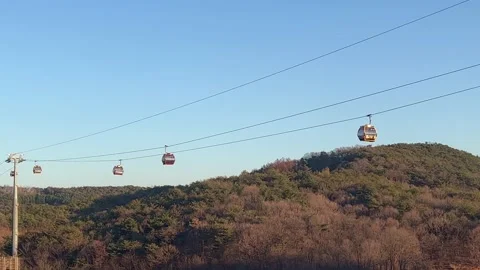 A sightseeing cable car passing up the mountain Stock Footage 236811206