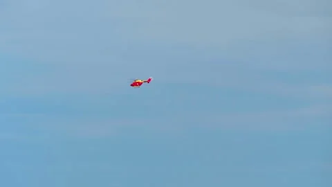 A sightseeing helicopter flies in the sky Stock Footage 257653480