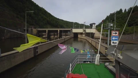 Sightseeing ship is navigating into a sluice at the Saar river loop Stock Footage 131378424