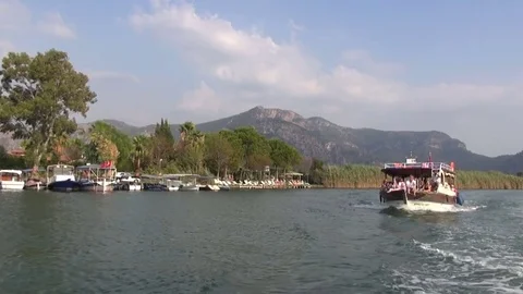 Sightseeing tour boat floating along the shore Stock Footage 70159210