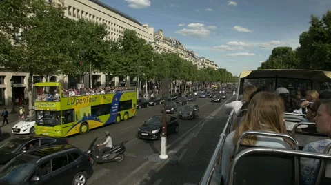 Sightseeing tour bus on Paris street with Parisian skyline behind. Stock Footage 60903353