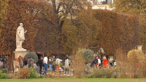 Sightseers exploring the pathways of Tuileries Garden in Paris in the Fall Stock Footage 231127337