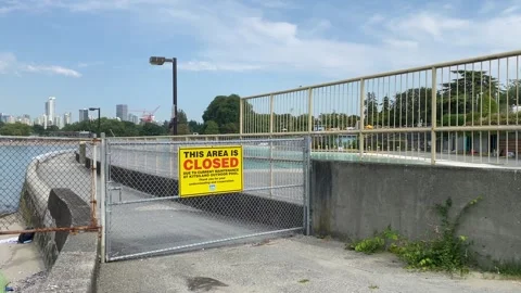Sign of This Area is closed towards pathway to beach and pool in Vancouver Stock Footage 280802204