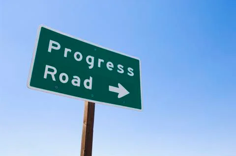 Sign with arrow toward Progress Road 스톡 사진