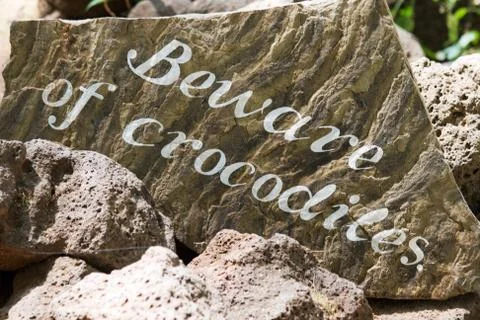 Sign: "beware of crocodiles" Stock Photos