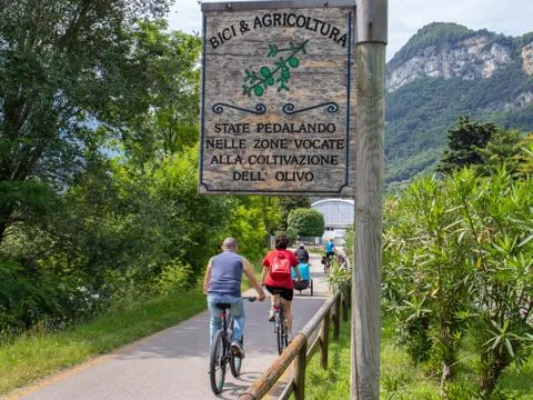 A sign on the bikeway of Arco alongside the Sarca River that inform the bikers Stock Photos