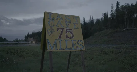 Sign board displaying the distance of nearest cafe in a rural area Stock Footage 104209482