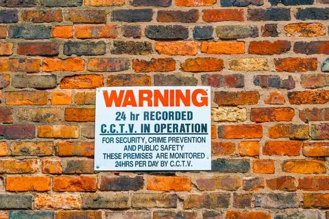 Sign on a brick wall stating CCTV is in operation Stock Photos