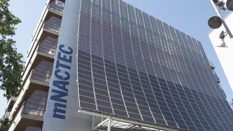 Sign building mNACTEC museum solar panel balcony tree sunlight Terrassa Stock Footage 344273172
