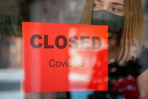 Sign Closed covid 19 lockdown on front entrance door as new normal shutdown i Stock Photos