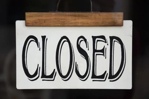 Sign Closed on the front window of a store. Black sign in Western-style font Stock Photos