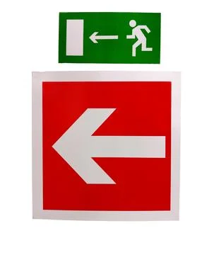 The sign of the direction to the evacuation exit on the wall in the shopping Ilustración de archivo