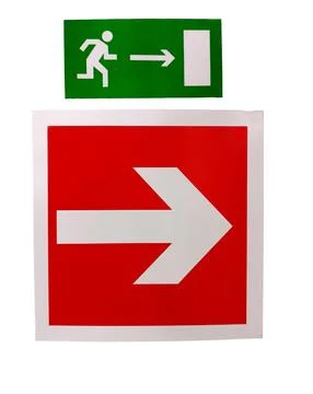 The sign of the direction to the evacuation exit on the wall in the shopping Ilustración de archivo