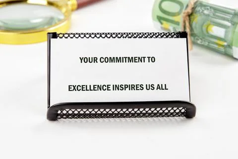 A sign emphasizes the importance of commitment to excellence in a workplace,  Stock Photos