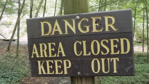 Sign on a Forest Trail Reads - Danger Area Closed Keep Out Stock Footage 81498533