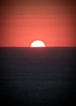 A sign in front of a sunset 写真素材