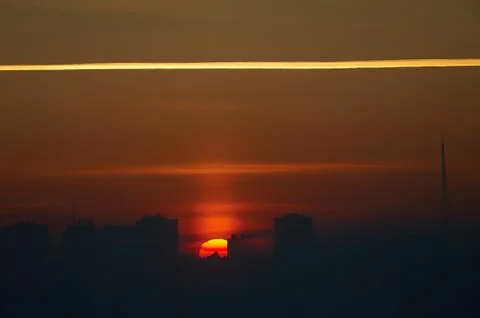 A sign in front of a sunset Stock Photos