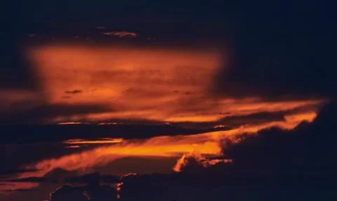 A sign in front of a sunset Stock Photos
