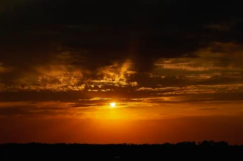 A sign in front of a sunset Stock Photos