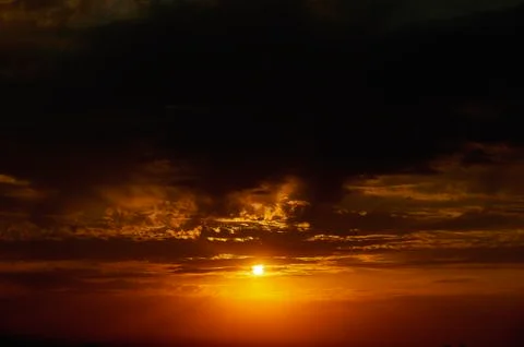 A sign in front of a sunset Stock Photos