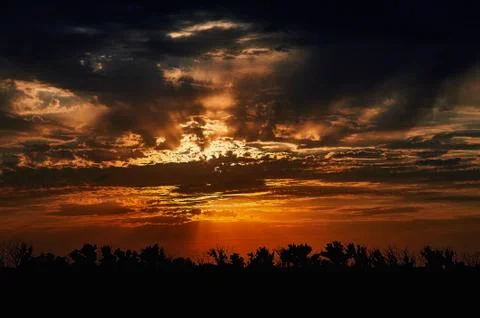A sign in front of a sunset Stock Photos