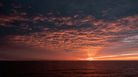 A sign in front of a sunset Foto stock