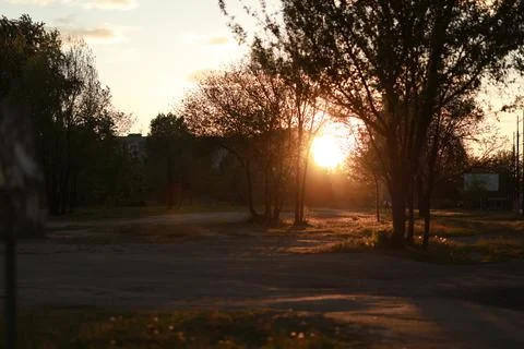 A sign in front of a sunset Stock Photos