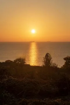 A sign in front of a sunset Stock Photos