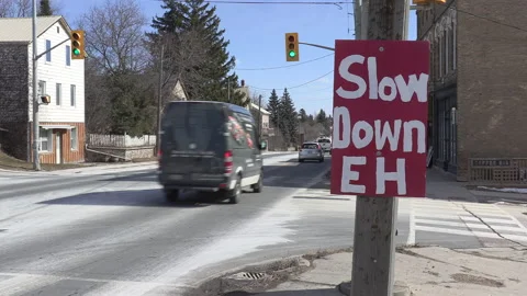 Sign on highway warning drivers to slow down and not speed in town Stock Footage 149897421