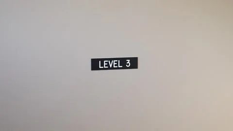 Sign Indicating Level 3 on a Plain Wall Stock Footage 276341755