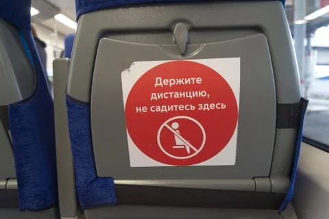 Sign "keep your distance, do not sit here" on the back of the seat Stock Photos