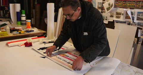 Sign maker applying graphics to a sign. Stock Footage 133085421