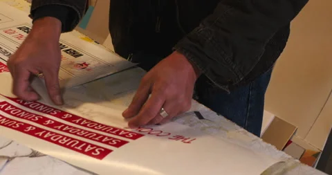 Sign maker applying graphics to a sign. Stock Footage 133085607