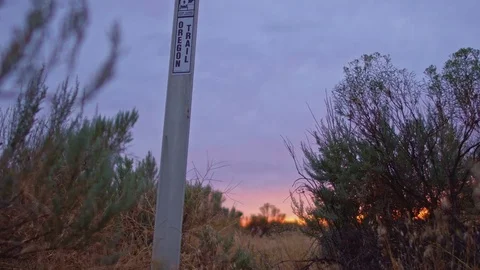 Sign that marks the Oregon Trail at Sunset and sagebrush Stock Footage 81873264