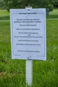 Sign outlining rules on a safe return to sport with COVID at an outdoor event Stock Photos