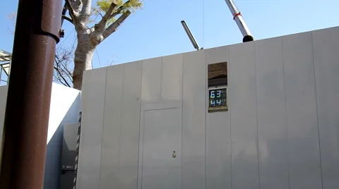 Sign outside of a construction site showing the decibel levels inside and out Stock Footage 43191571
