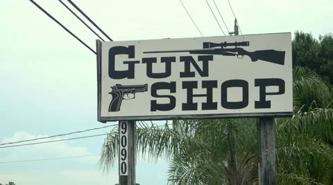 Sign outside saying GUN SHOP Stock Footage