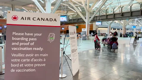 Sign Please have your boarding pass and proof of vaccination ready at YVR Stock Footage 169192040