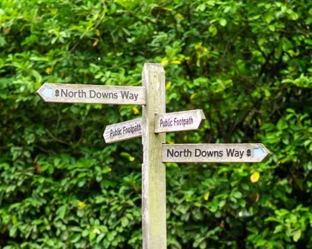 A sign post for the north downs way in guildford surrey against a blurred gre Stock Photos