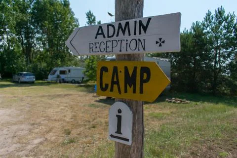 Sign post with text - administration, reception, camp, info''. Tourist camp b Stock Photos