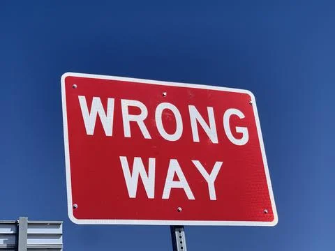 Sign post with wrong way sign Stock Photos