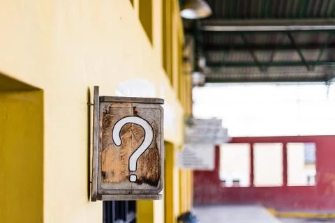 Sign with question mark in middle of bus station Stock Photos