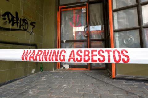 Sign reads: Warning - Asbestos removal in progress Stock Photos