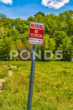 Sign that reads Warning No Trespassing Ogden City Police Letter Of Agency Stock Photos