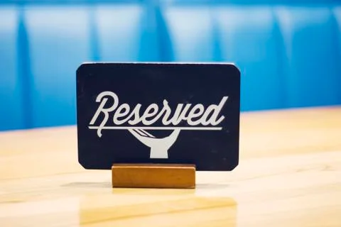 The sign Reserved on the empty table in a cafe Stock Photos