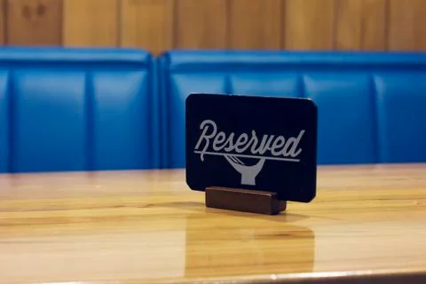 The sign Reserved on the empty table in a cafe Stock Photos