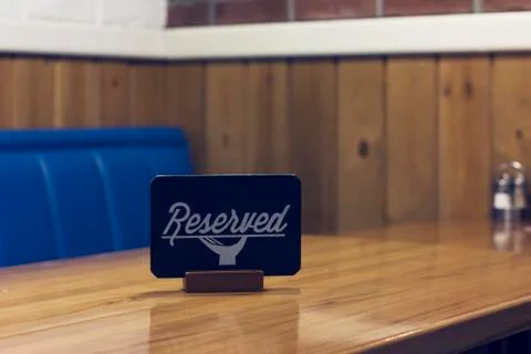 The sign Reserved on the empty table in a cafe Stock Photos