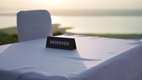 A sign RESERVED on the table of a cafe or restaurant with a lake view Stock Footage 249740878