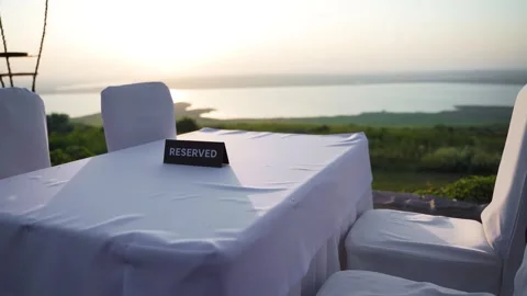 A sign RESERVED on the table of a restaurant or cafe with a lake view Stock Footage 249159456